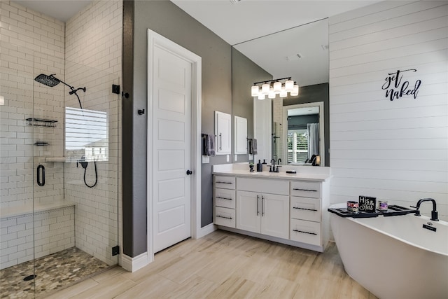 bathroom featuring hardwood / wood-style floors, vanity, and separate shower and tub