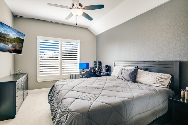 carpeted bedroom with ceiling fan and vaulted ceiling