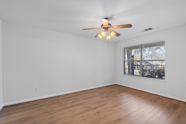 empty room with ceiling fan and hardwood / wood-style floors