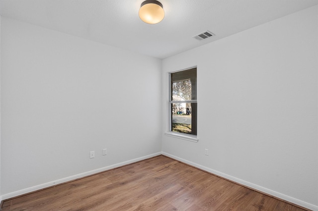 empty room with light hardwood / wood-style flooring