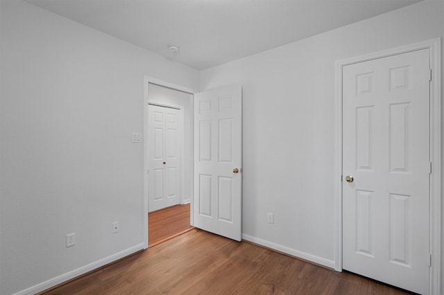 unfurnished bedroom featuring hardwood / wood-style flooring