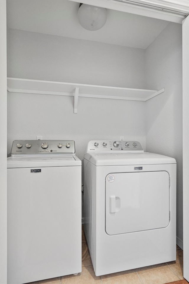 washroom featuring separate washer and dryer and light tile patterned floors