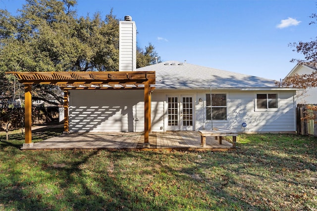 back of property with a patio area, french doors, a wooden deck, a yard, and a pergola