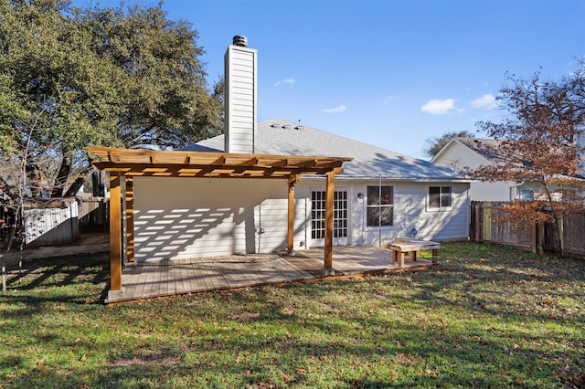 back of house featuring a lawn and a pergola