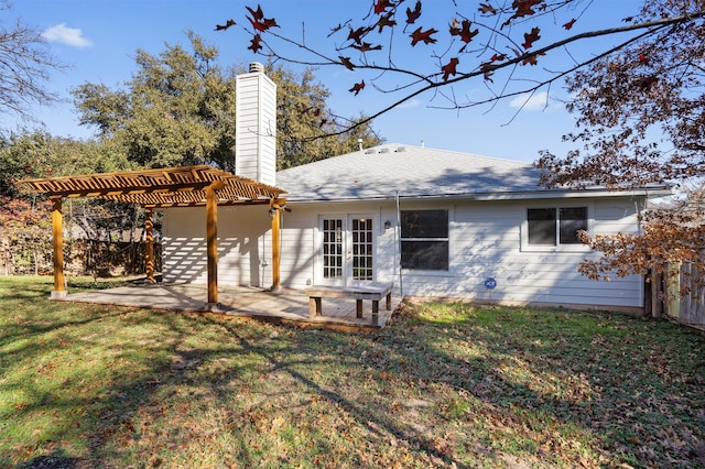 rear view of property featuring french doors, a pergola, a yard, and a patio