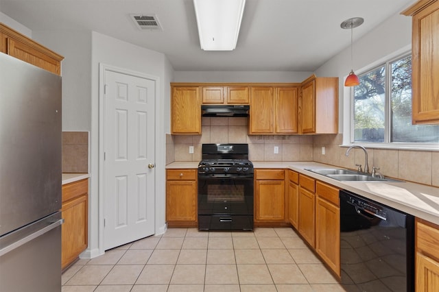 kitchen featuring black appliances, decorative light fixtures, sink, backsplash, and light tile patterned floors