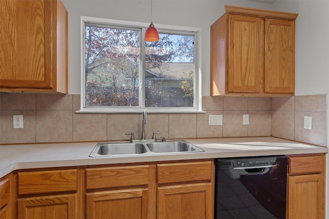 kitchen featuring decorative backsplash, sink, black dishwasher, and pendant lighting