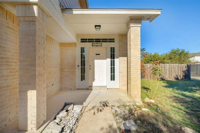 doorway to property featuring a lawn