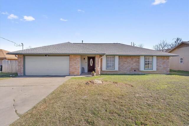 ranch-style home with a front yard and a garage