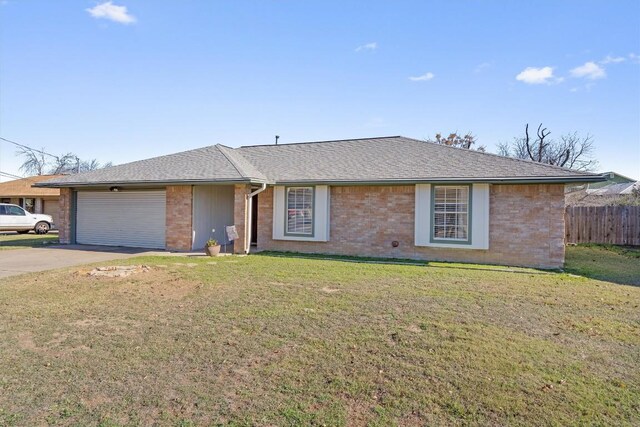 ranch-style home featuring a garage and a front lawn