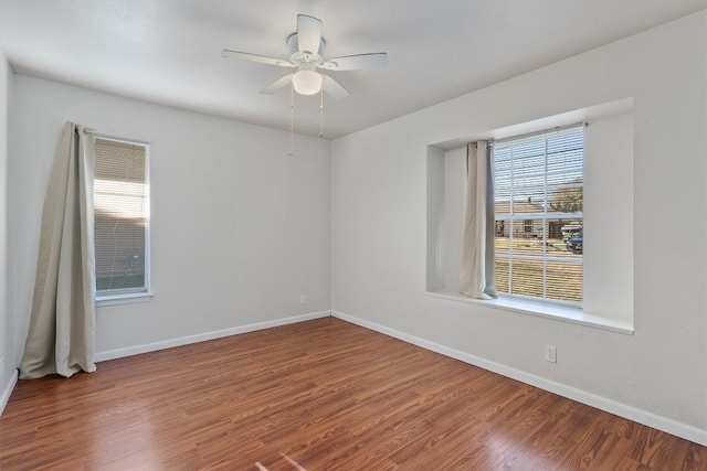 spare room with hardwood / wood-style flooring and ceiling fan