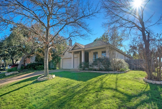 view of front facade with a garage and a front lawn