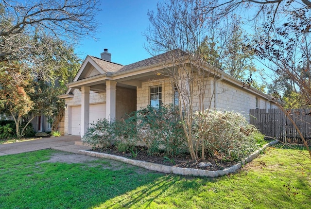 view of side of home with a lawn and a garage