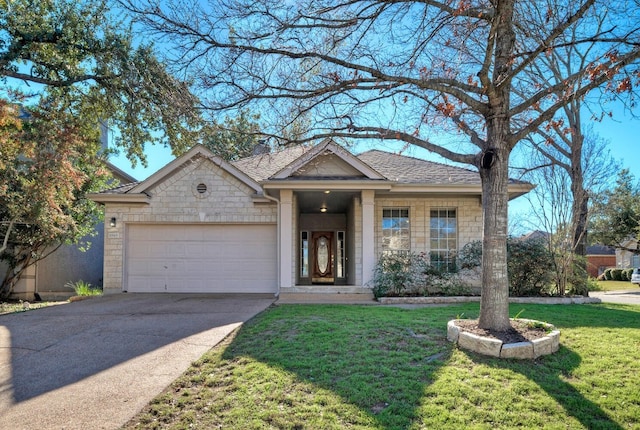 view of front of property featuring a front yard and a garage