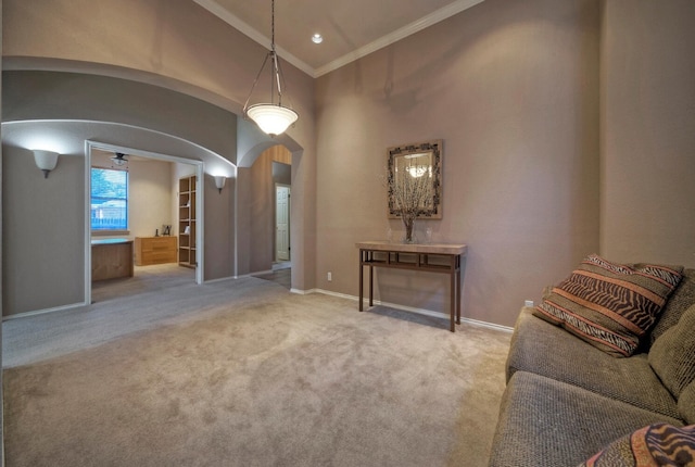 interior space featuring ceiling fan, ornamental molding, light carpet, and lofted ceiling