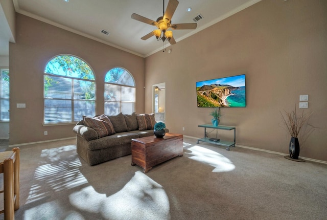 living room with ceiling fan, carpet floors, a healthy amount of sunlight, and ornamental molding