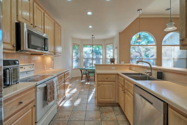 kitchen featuring sink, stainless steel appliances, decorative light fixtures, decorative backsplash, and light brown cabinetry