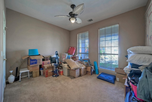 interior space featuring ceiling fan and carpet floors