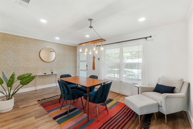 dining area featuring crown molding and light hardwood / wood-style floors