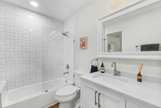 full bathroom featuring vanity, toilet, and tiled shower / bath