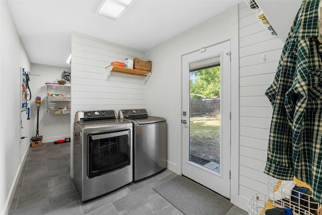 clothes washing area with separate washer and dryer