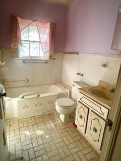 bathroom with vanity, toilet, and a bath