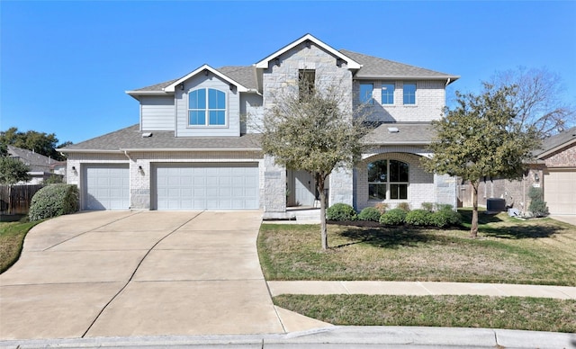 view of front of house with cooling unit, a garage, and a front lawn