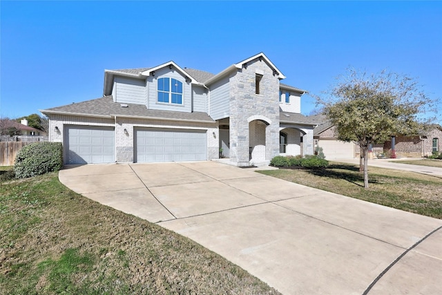 view of front of home featuring a garage and a front yard