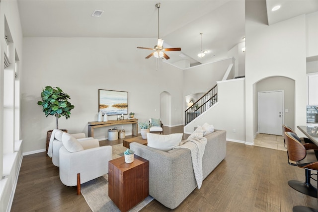 living room featuring ceiling fan, dark hardwood / wood-style flooring, and high vaulted ceiling