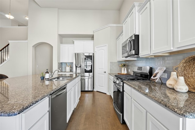 kitchen featuring backsplash, white cabinetry, sink, and stainless steel appliances