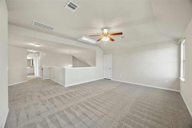 carpeted spare room with ceiling fan and lofted ceiling