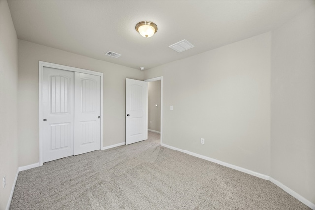 unfurnished bedroom with carpet flooring and a closet