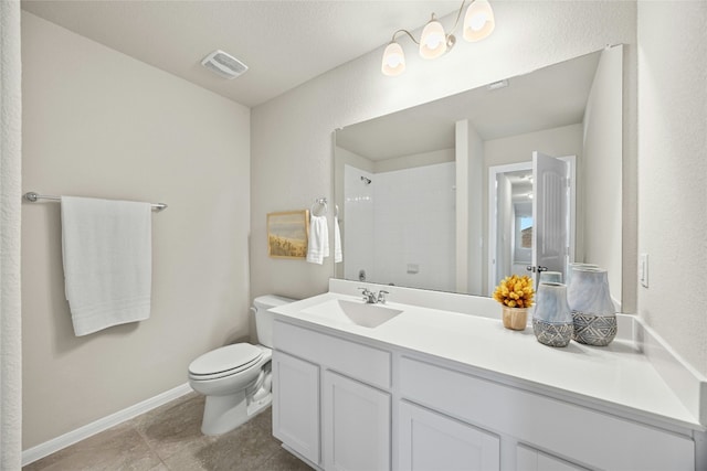 bathroom featuring toilet, vanity, and walk in shower