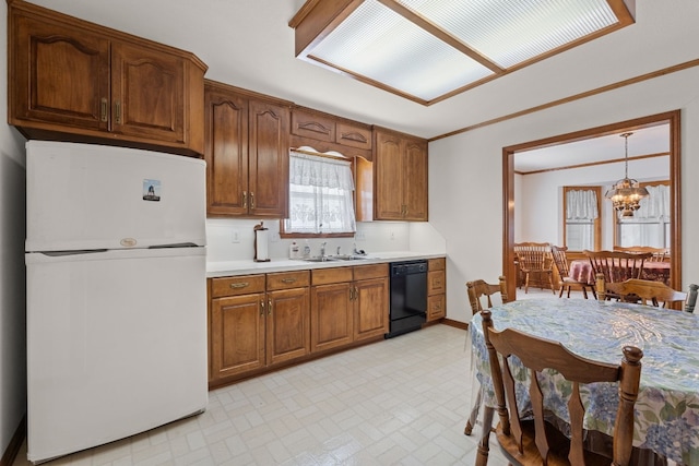 kitchen featuring sink, black dishwasher, white fridge, a chandelier, and pendant lighting