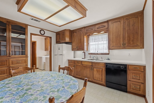 kitchen featuring black dishwasher, white refrigerator, and sink