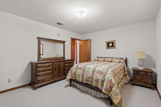 carpeted bedroom featuring a textured ceiling