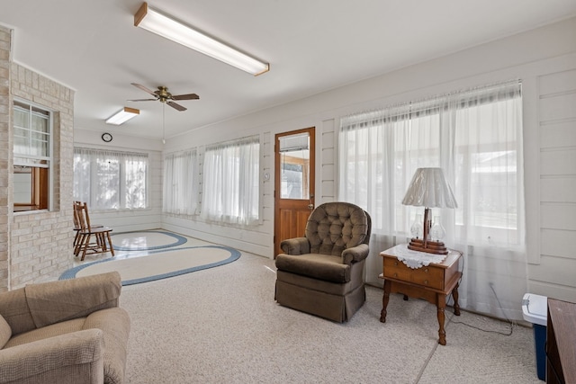 living room with ceiling fan and a wealth of natural light