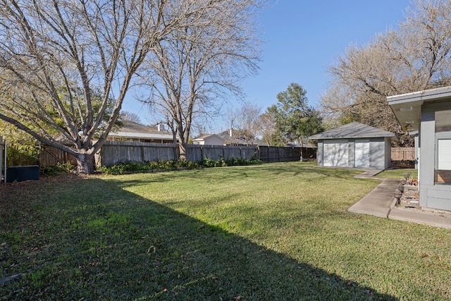 view of yard featuring a garage and an outbuilding