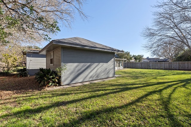 view of side of property with a lawn