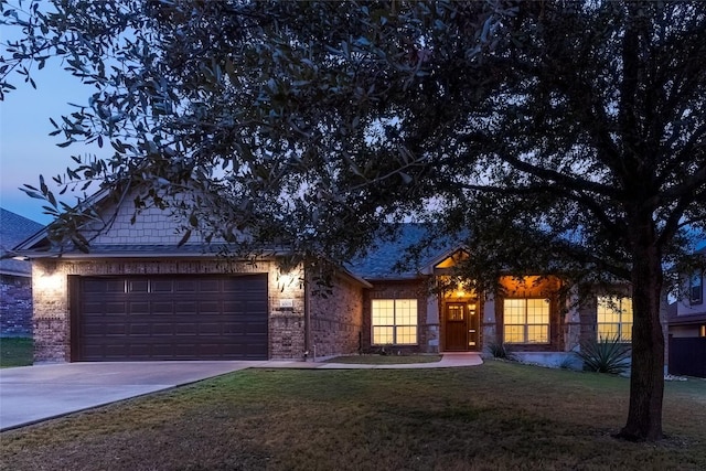 single story home with a front yard and a garage