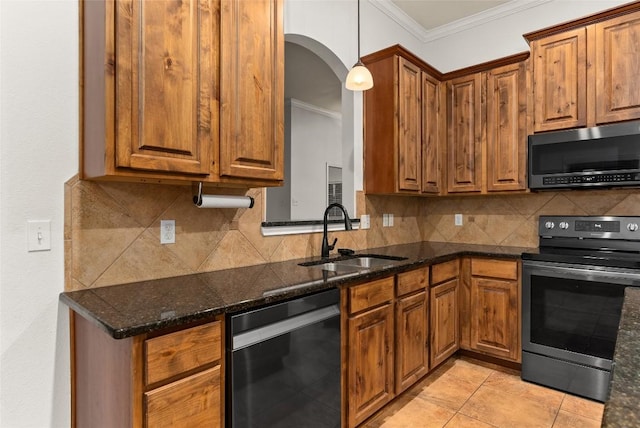 kitchen with dark stone counters, crown molding, sink, appliances with stainless steel finishes, and light tile patterned flooring