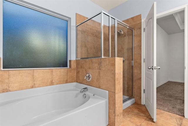 bathroom featuring tile patterned floors and shower with separate bathtub