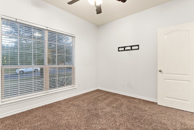 carpeted spare room with ceiling fan