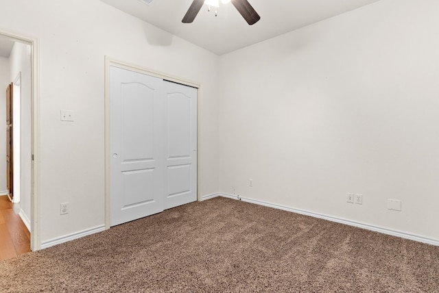 unfurnished bedroom featuring ceiling fan, a closet, and carpet