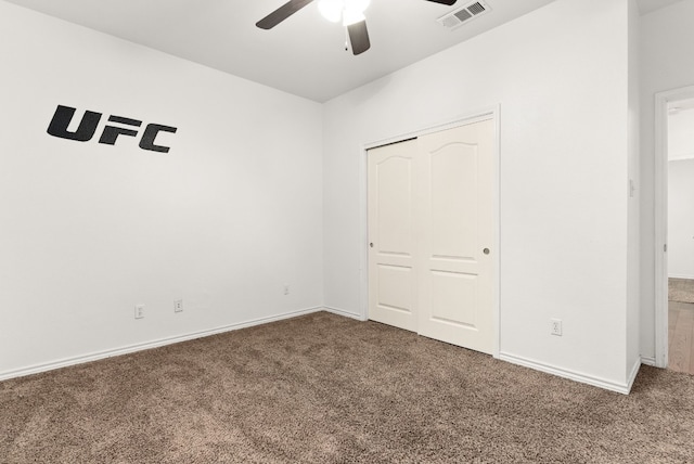 unfurnished bedroom with carpet, ceiling fan, and a closet