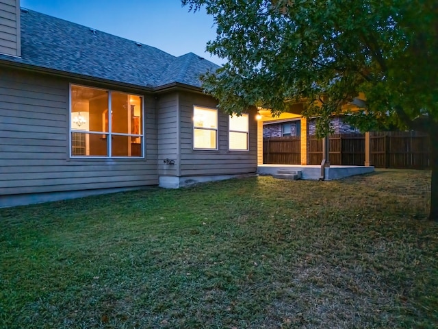 rear view of house with a yard and a patio area