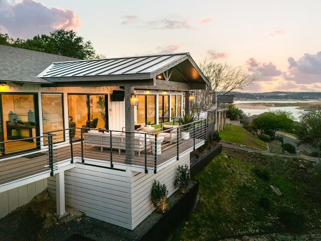 back house at dusk with a water view