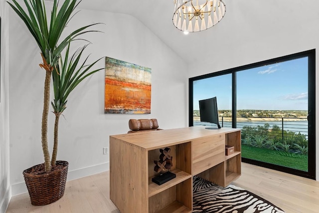 office with lofted ceiling, light hardwood / wood-style floors, and a chandelier