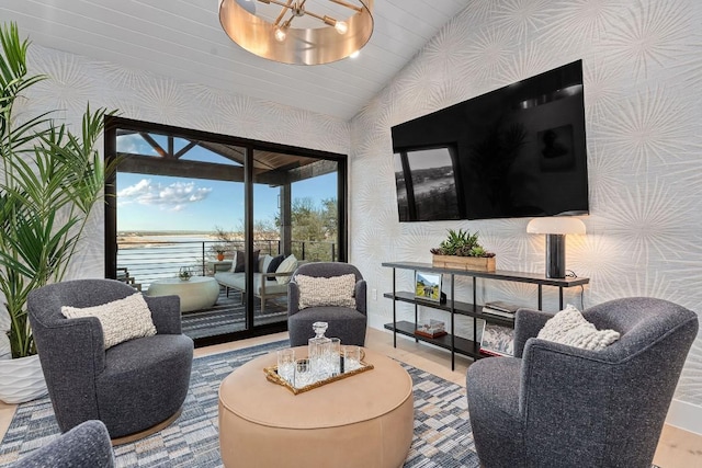 living room featuring lofted ceiling and a notable chandelier