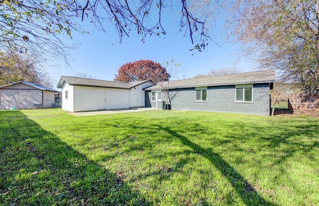 back of property featuring central AC unit, a patio area, and a yard